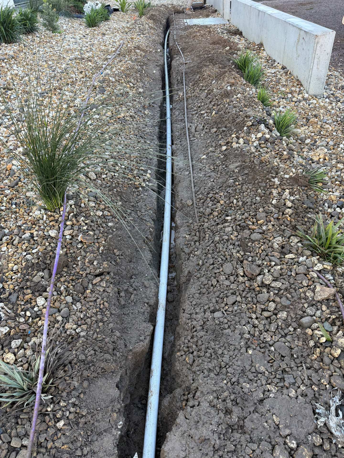 Communications conduit installed in an open trench