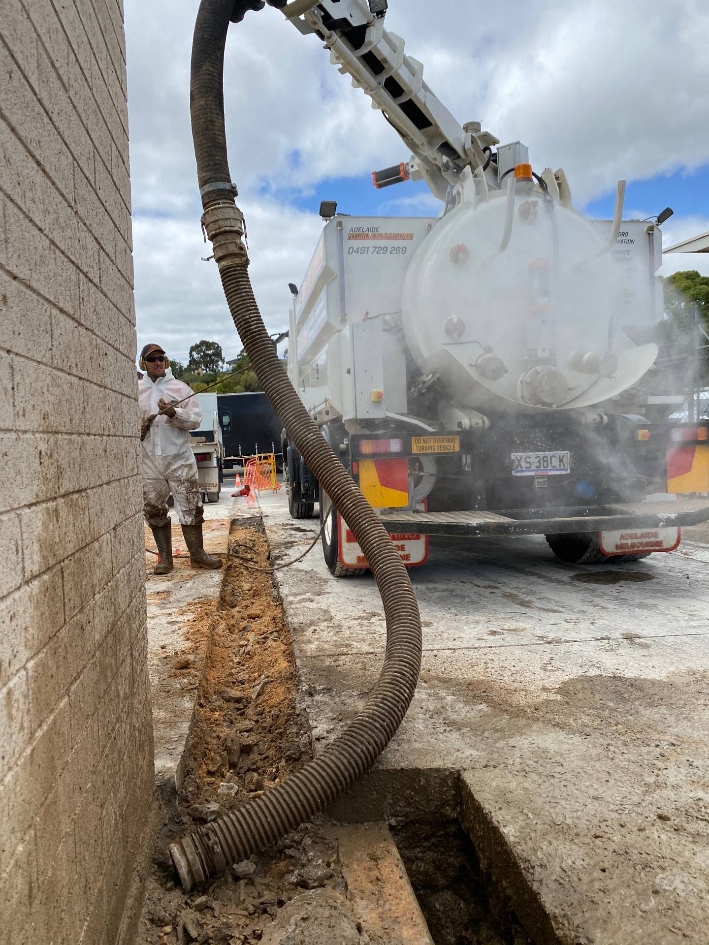 Vacuum excavation potholing to expose services under pavers